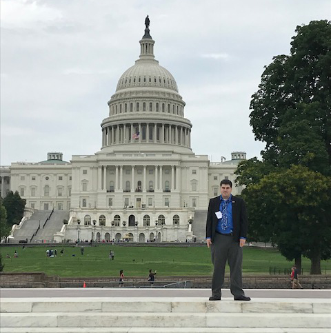 HT employee standing at the steps of the Capitol Building