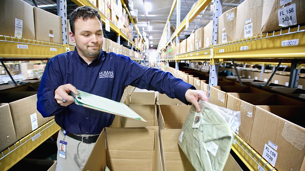 HT employee packing a shirt into a box