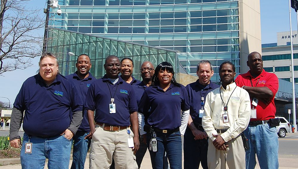 Ht employees posing out front of a building