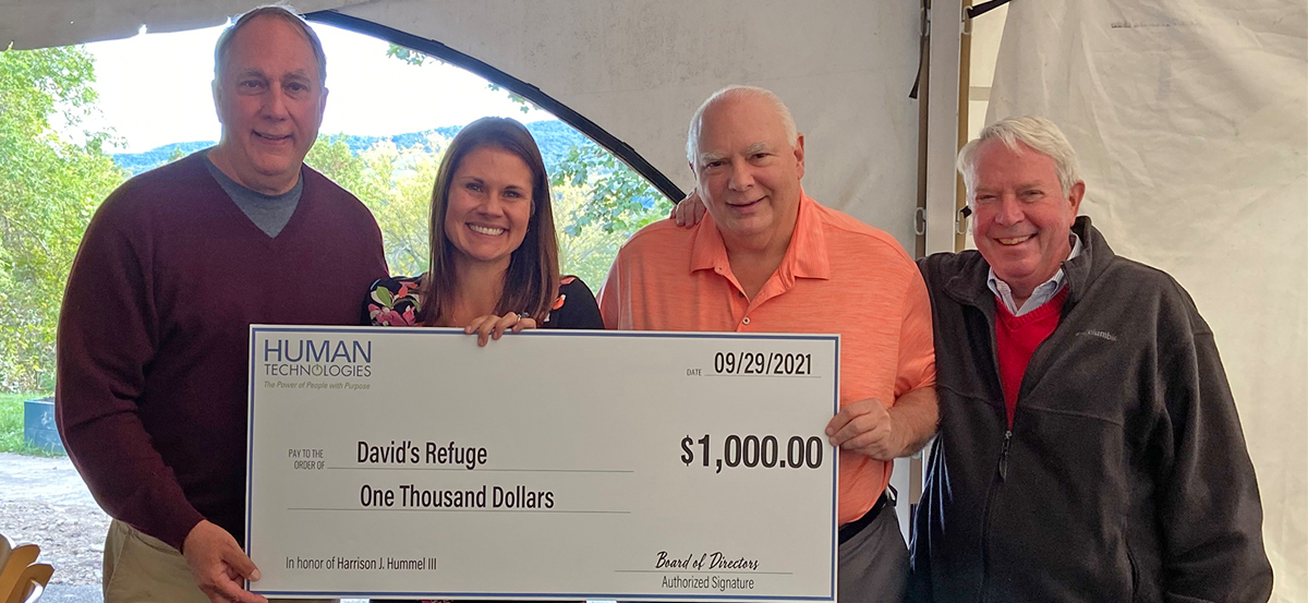 Tim Giarrusso presenting a $1,000 check to members of David's Refuge
